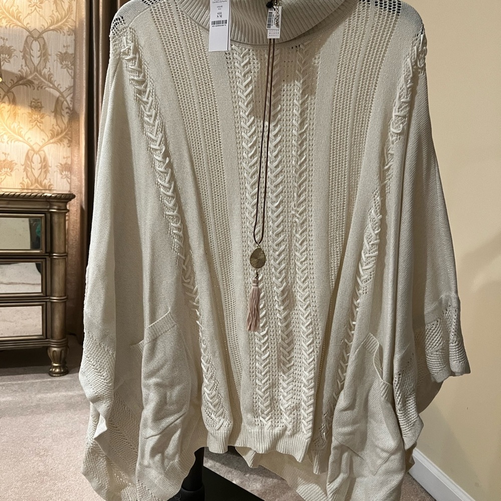 Cream poncho and necklace